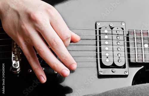 Close up of an electric guitar being played