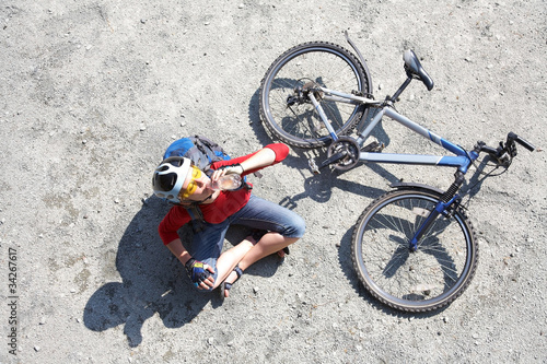 young cyclist rest near bike