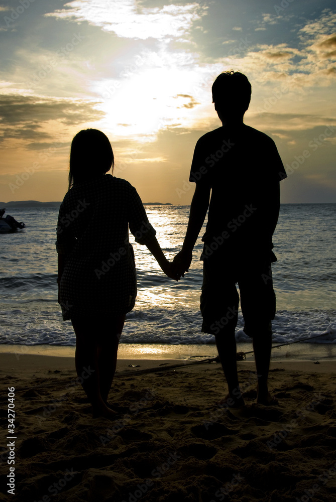 A Couple on the Beach at Sunset