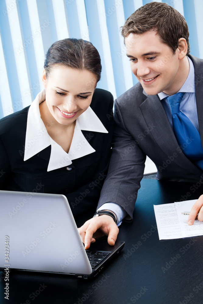 Two businesspeople working with laptop at office Two businesspeople working with laptop at office