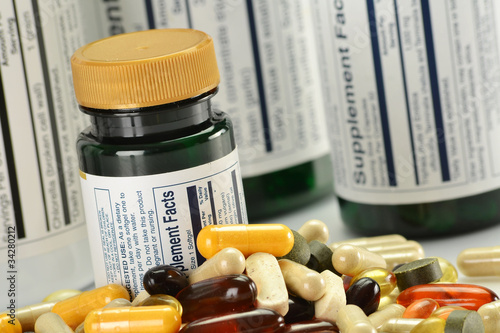 Composition with dietary supplement capsules and containers photo