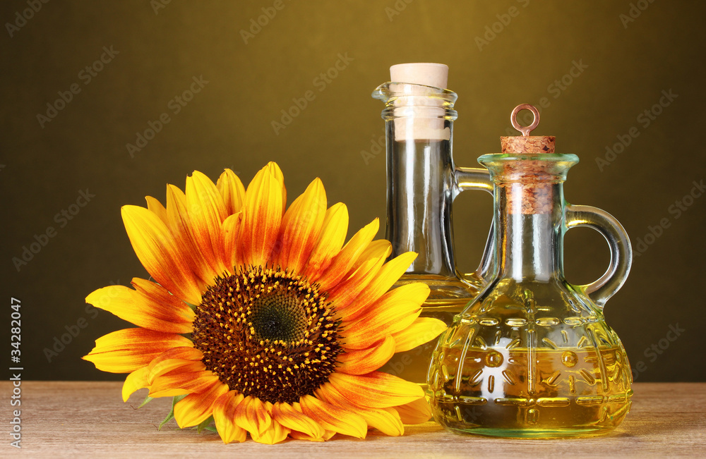 sunflower oil and sunflower on yellow background sunflower oil and sunflower on yellow background
