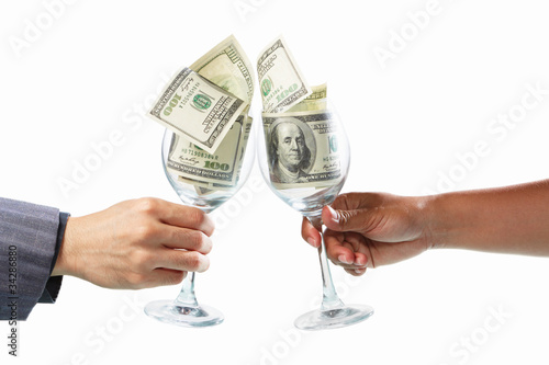 Toast using glass filled with dollar bills