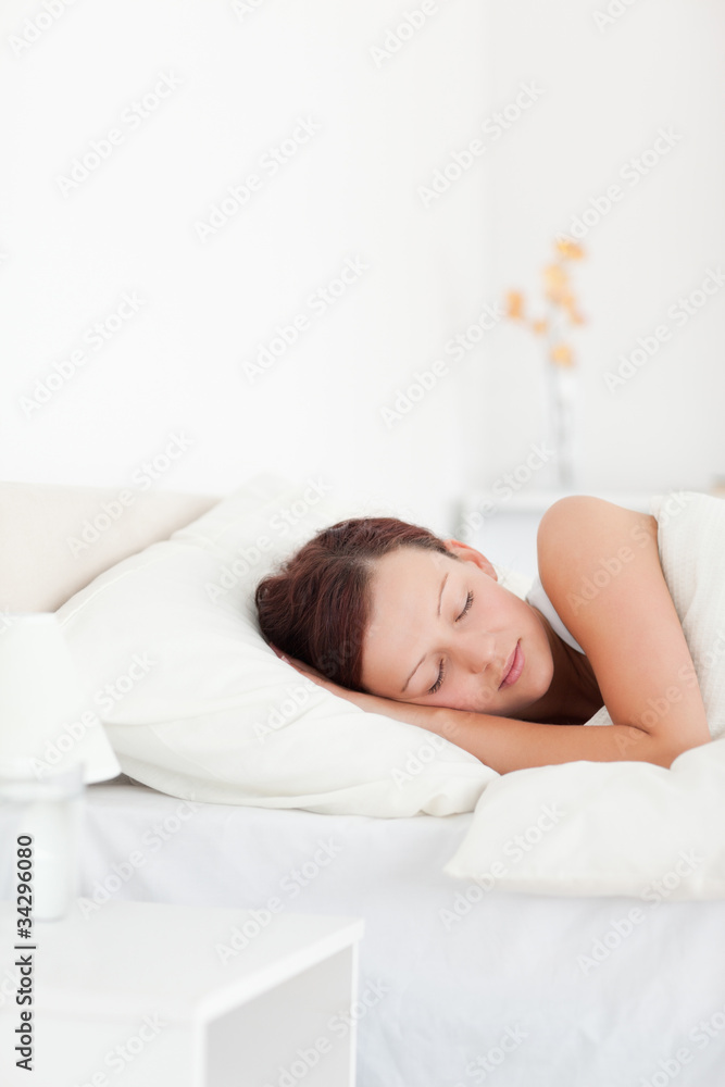 Red-haired woman lying in bed sleeping Red-haired woman lying in bed sleeping