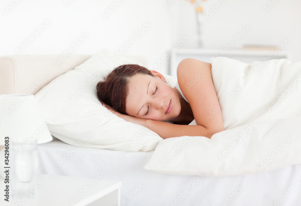 Beautiful Red-haired woman lying in bed sleeping - obrazy, fototapety, plakaty 