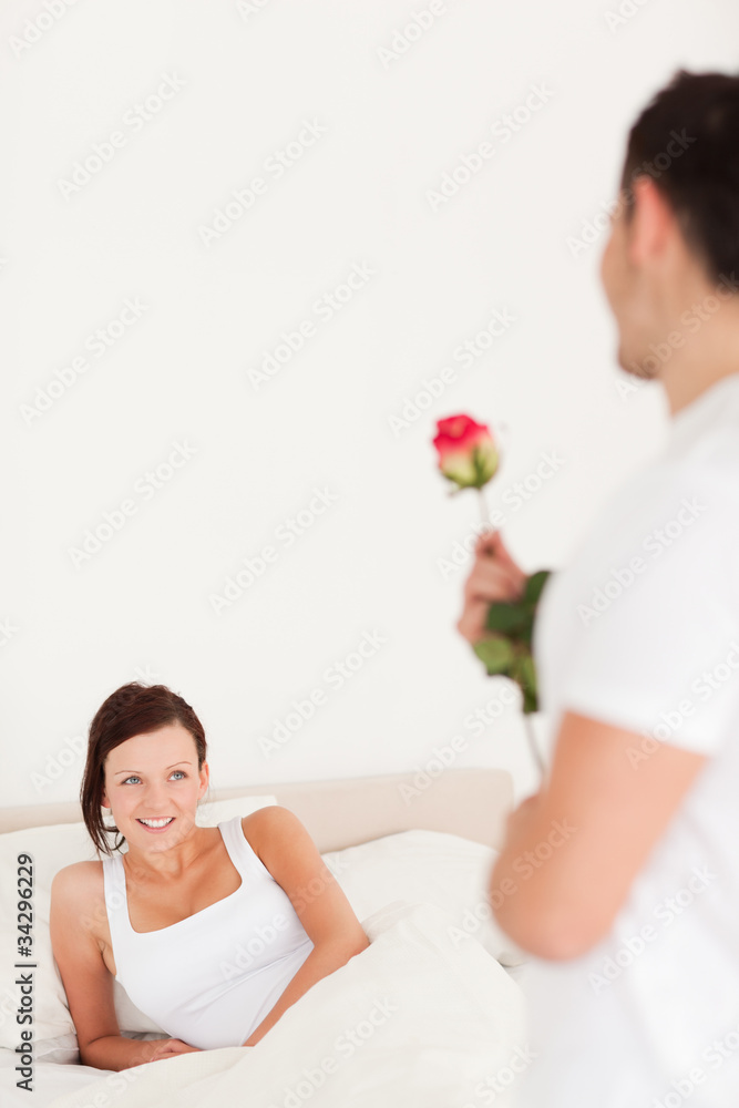 Handsome guy with a rose looking into the camera Handsome guy with a rose looking into the camera