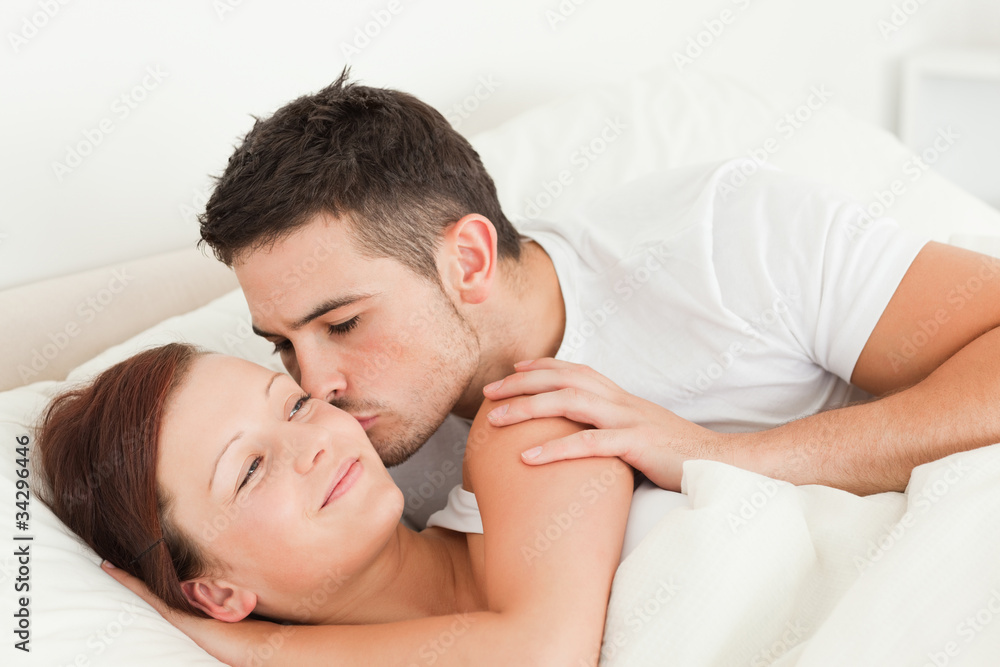 Man kissing his wife on the cheek Man kissing his wife on the cheek