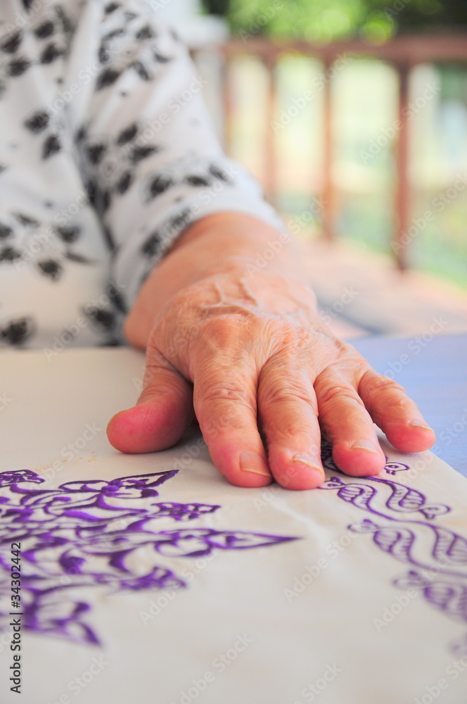 a wrinkled hand on table a wrinkled hand on table