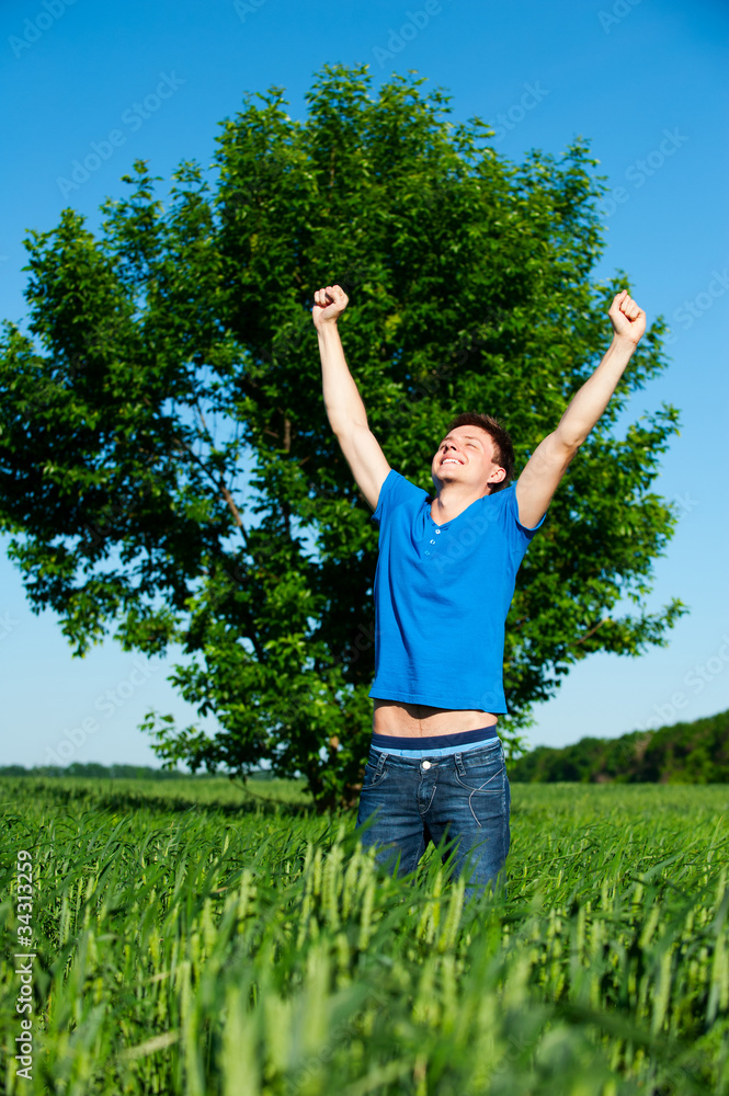 happy man against tree and blue sky happy man against tree and blue sky
