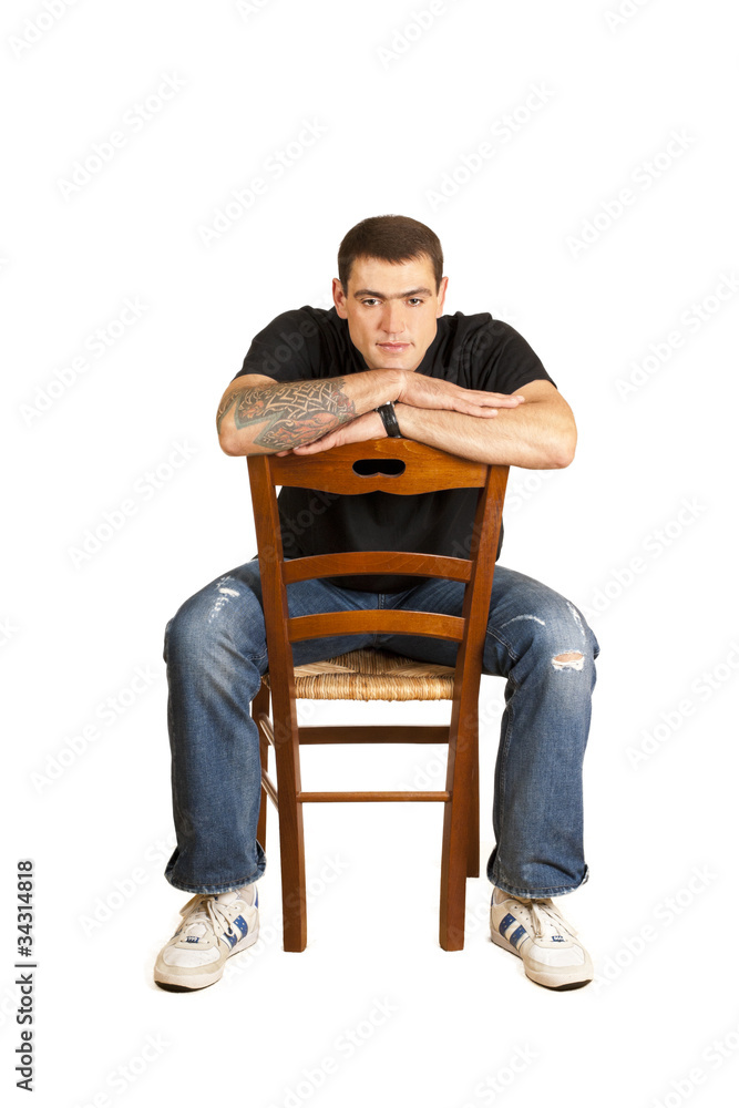 handsome young man sitting on a chair