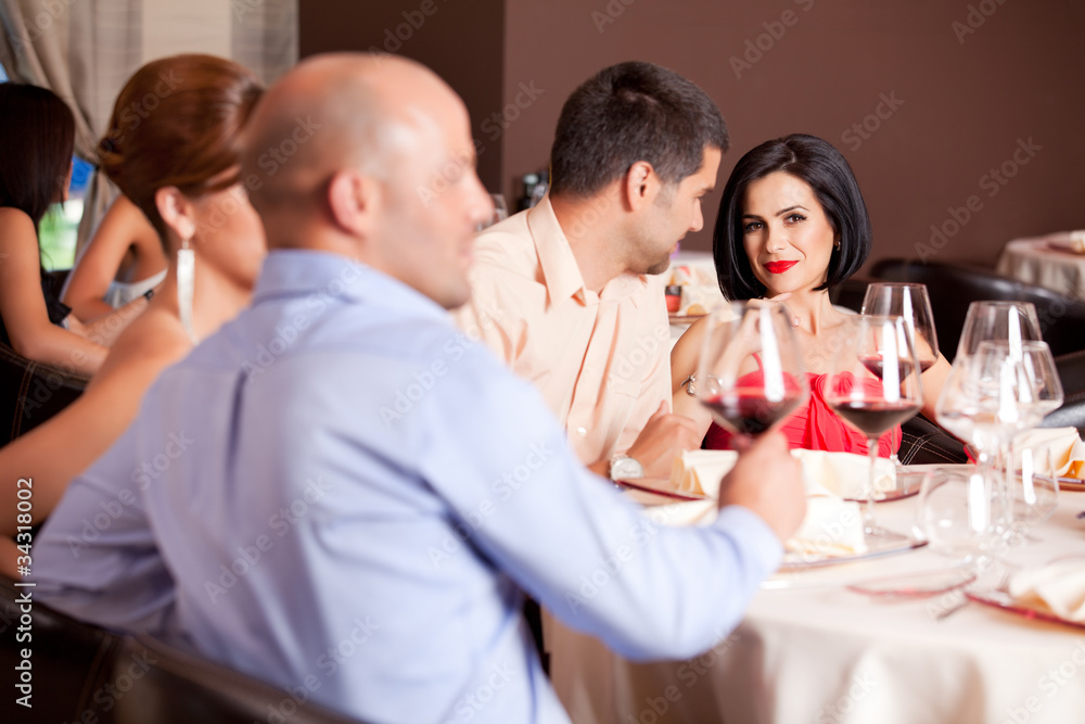 happy couple at restaurant table talking
