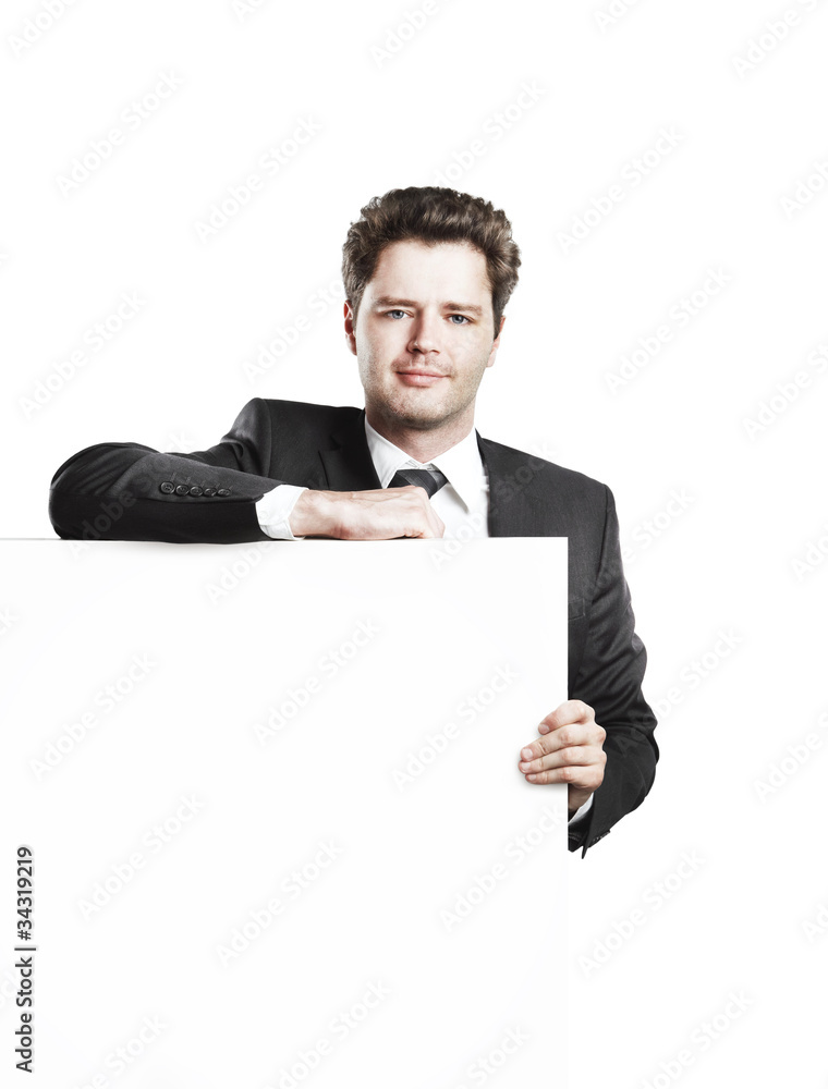 Young businessman holding a blank white board Young businessman holding a blank white board