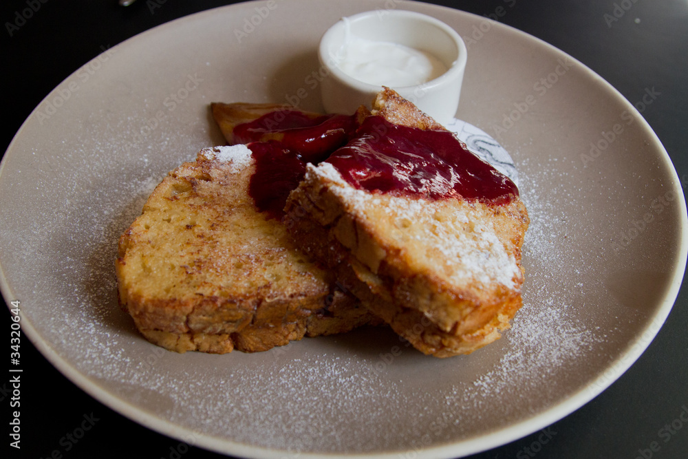 French toast with syrup, powdered sugar, fruits and cream French toast with syrup, powdered sugar, fruits and cream