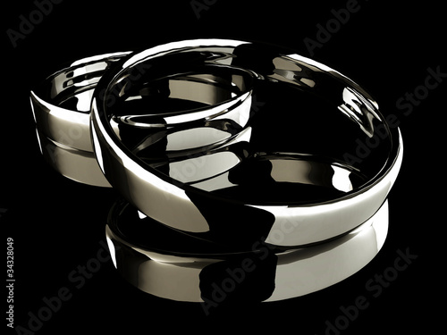 Platinum wedding rings on black background