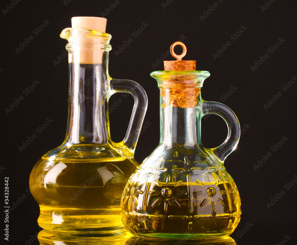 olive oil in jars on black background olive oil in jars on black background