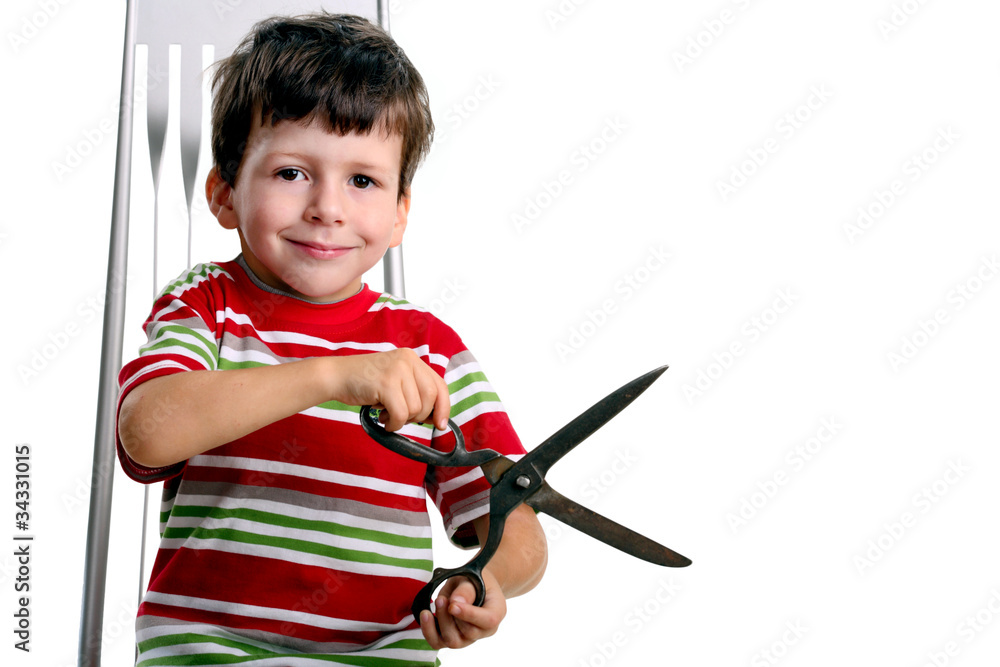 Child with big scissors sit on chair Child with big scissors sit on chair