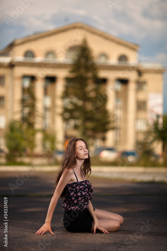 young woman sitting at the street in city © yuriyzhuravov