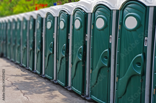 Row of porta potty outhouses ready for use