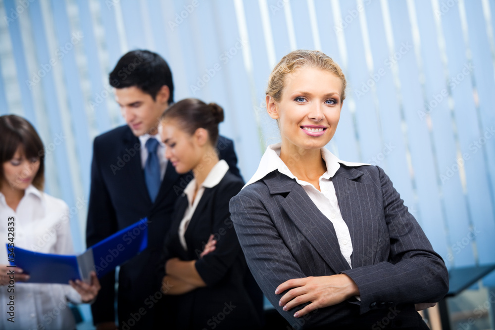 Portrait of happy smiling businesswoman and colleagues Portrait of happy smiling businesswoman and colleagues