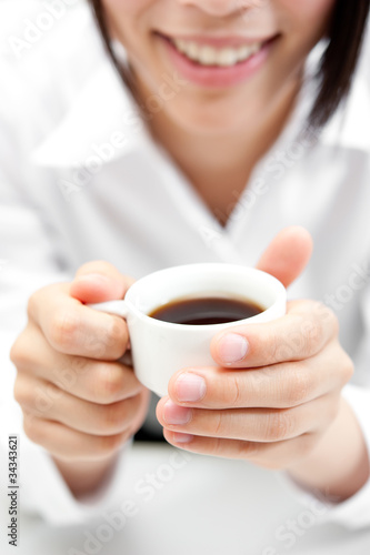 a woman drinking a cup of coffee
