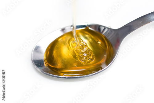 Honey dripping down on spoon