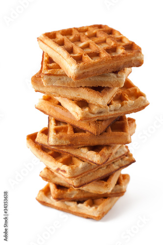 Big pile of fresh Belgian waffles on a white background