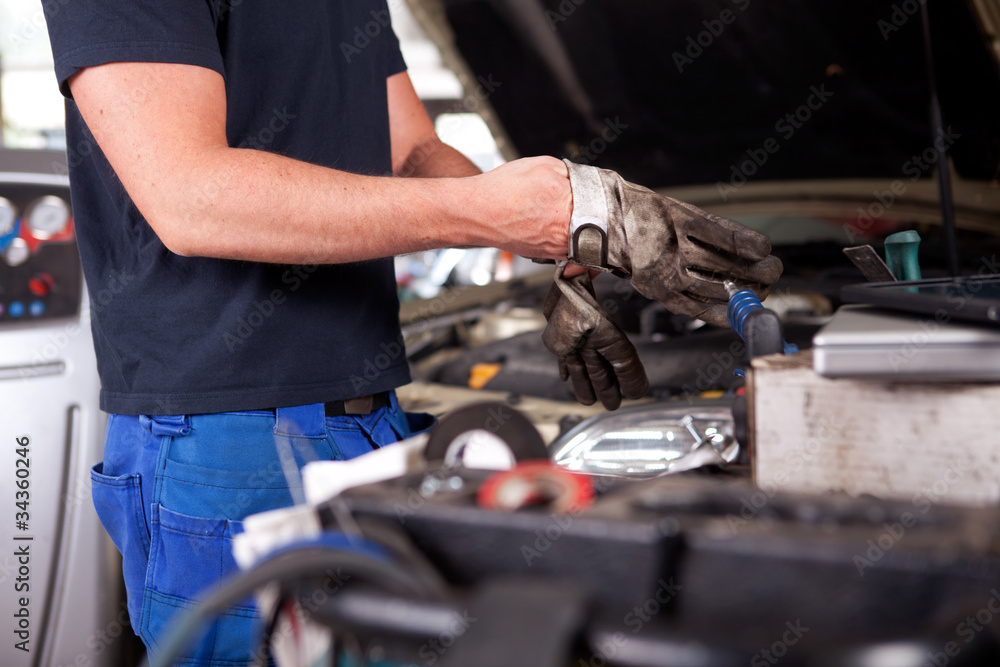 Mechanic Putting on Work Gloves