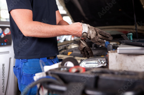 Mechanic Putting on Work Gloves