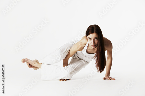 Woman in sideways crow pose (Ashtavakrasana) photo