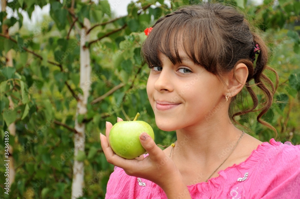 The girl with green apple on the background of birch The girl with green apple on the background of birch