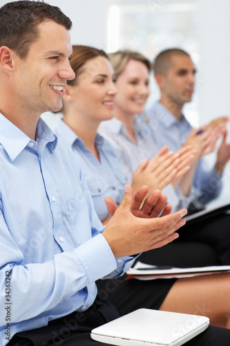 Group applauding business presentation