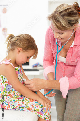 Female doctor examining child photo