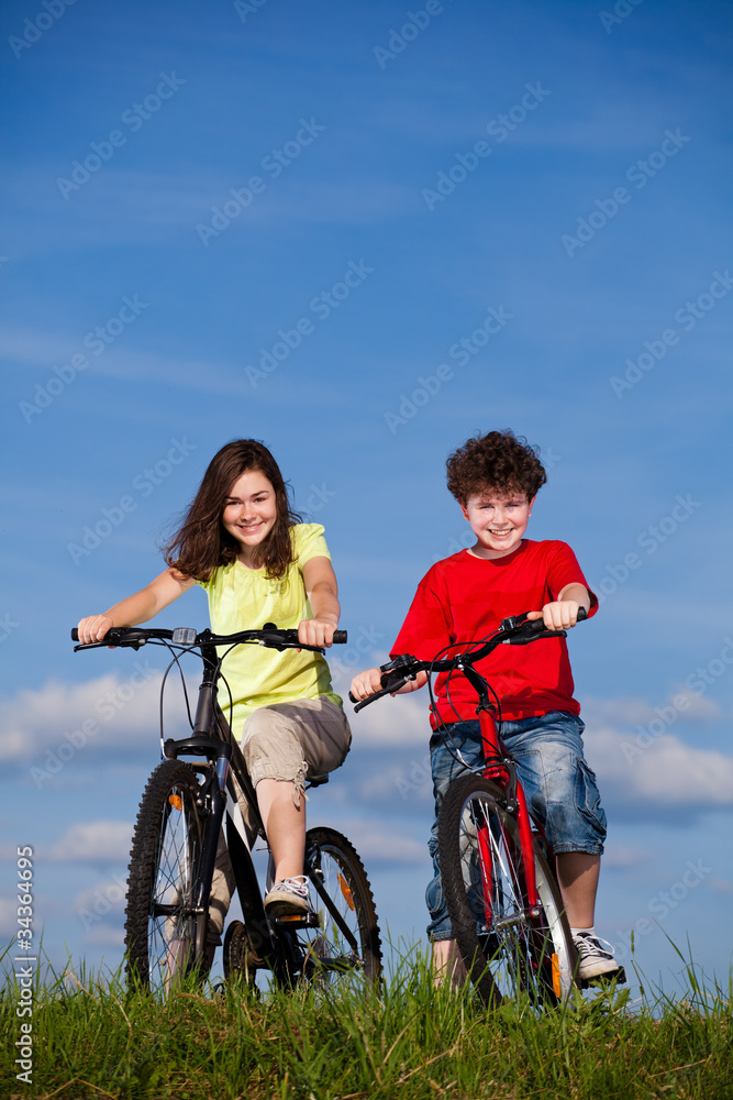 Girl and boy riding bikes