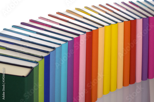Close-up of rainbow-colored book arrangement