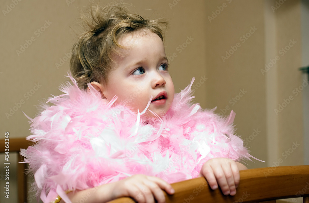 little child wrapped in feathery pink boas little child wrapped in feathery pink boas