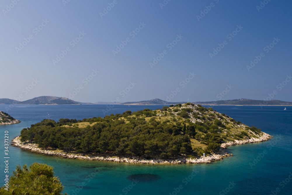 Green island in the aquamarine sea