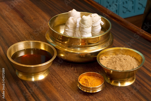 herbs powder and oil in bronze cups