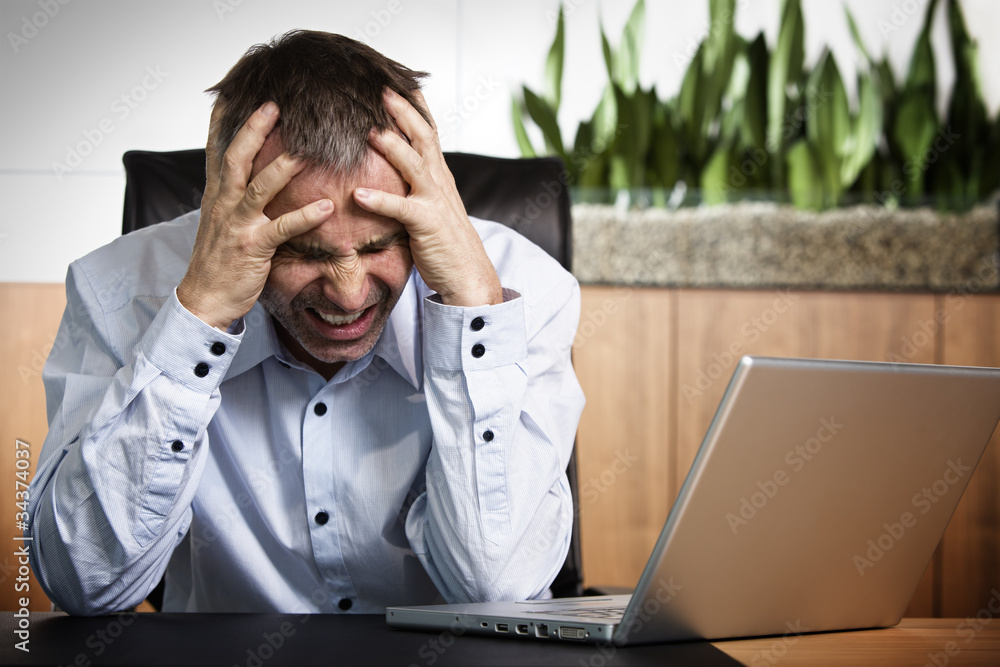 Angry business manager in front of office computer. Angry business manager in front of office computer.
