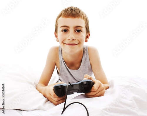 Photo of the boy with joystick playing computer game