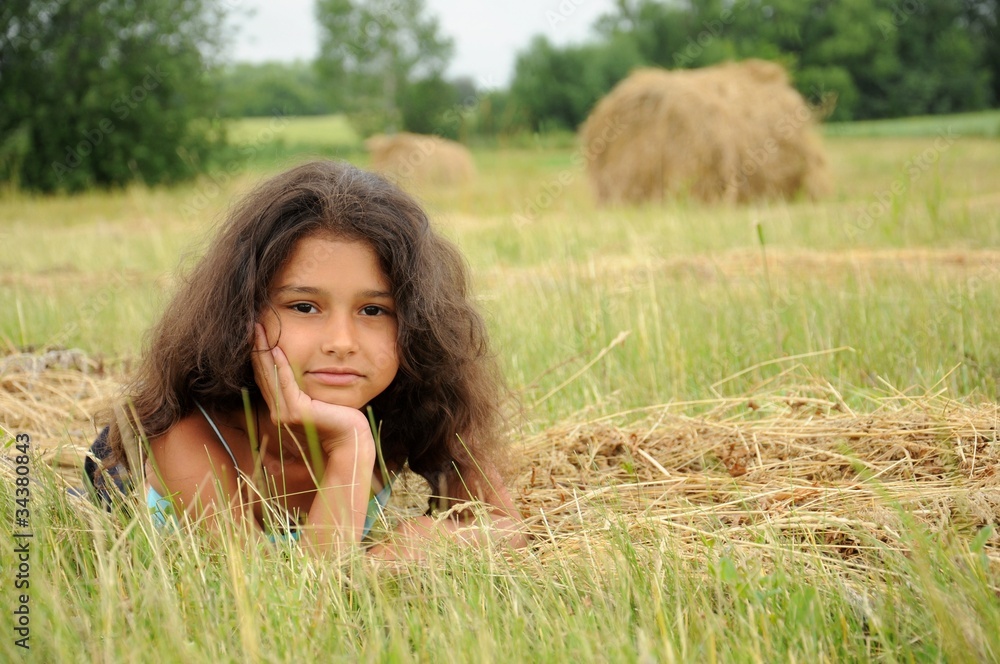 Beautiful girl in a field on a background of straw Beautiful girl in a field on a background of straw