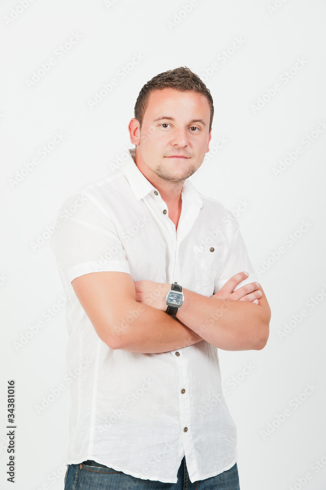 Portrait of a happy young man standing with arms crossed Portrait of a happy young man standing with arms crossed