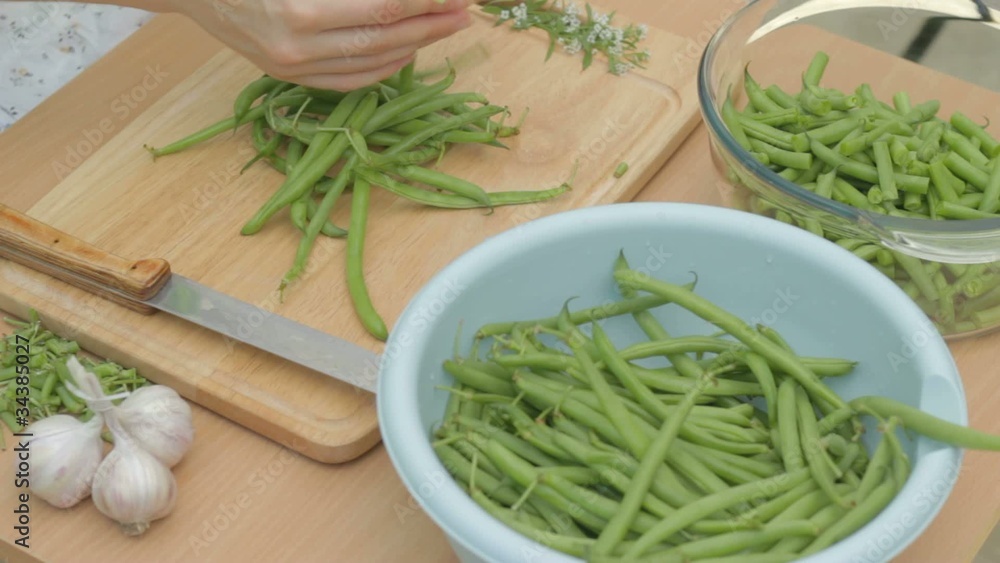 Collecting each pod of fresh green bean for further cutting Collecting each pod of fresh green bean for further cutting