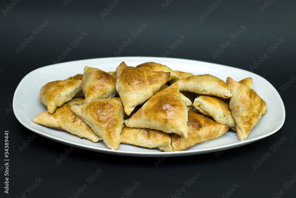 Asian pies with meat samsa, on the black background