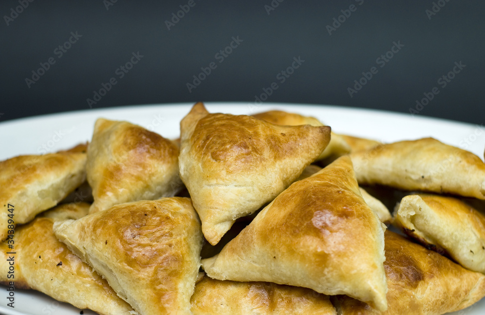 Asian pies with meat samsa, on the black background Asian pies with meat samsa, on the black background