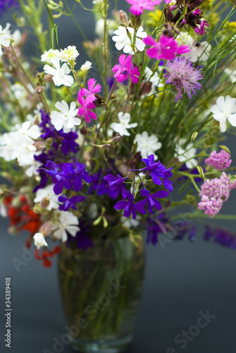 Bucket of summer fresh wild flowers isolated on black background