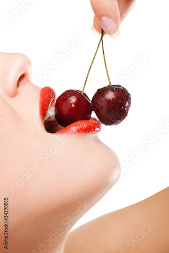 young woman's mouth with red cherries