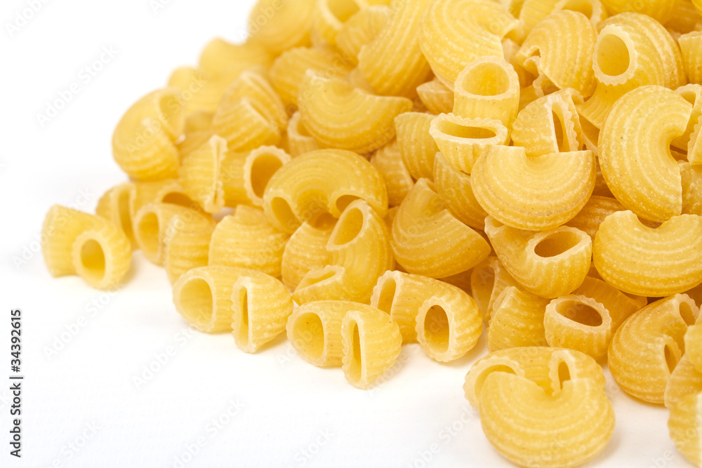 close up of a dried italian pasta on white background close up of a dried italian pasta on white background