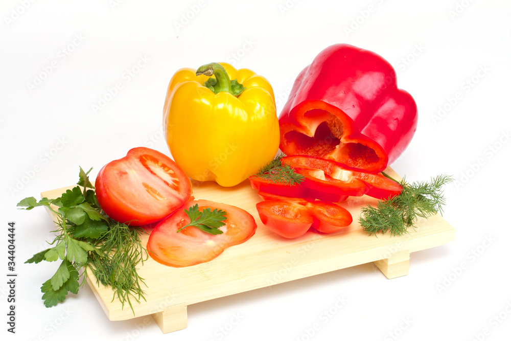Pepper, tomato with dill and parsley on the wood desk isolated Pepper, tomato with dill and parsley on the wood desk isolated