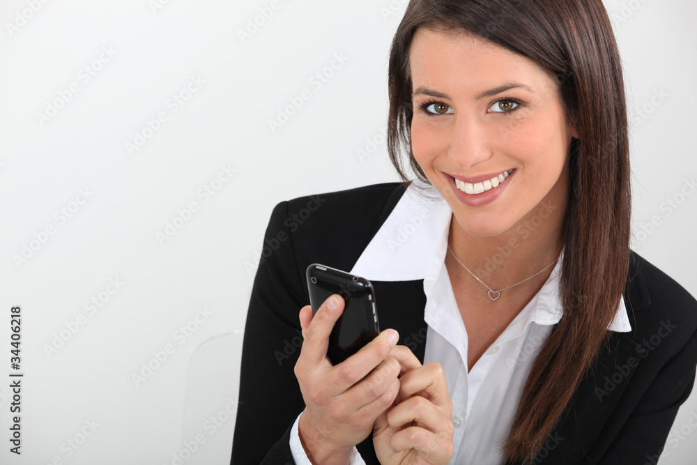 Smart young businesswoman using a smartphone Smart young businesswoman using a smartphone