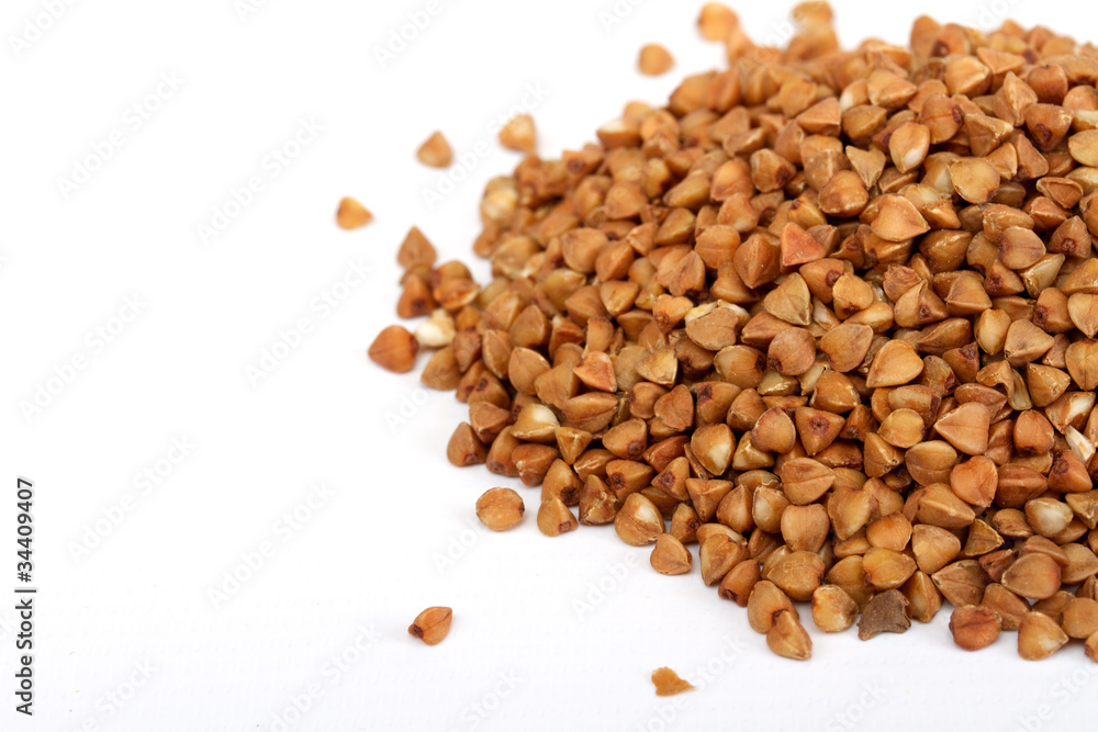 Isolated buckwheat on white background. Handful of grain Isolated buckwheat on white background. Handful of grain